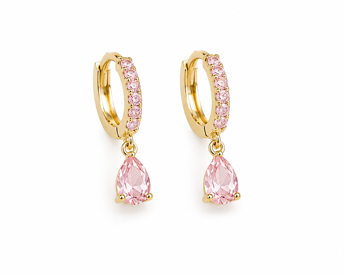Title: Blush Pink Teardrop Huggie Earrings | 18K Gold-FilledDescriptionAdd a soft touch of elegance and sparkle to your jewelry collection with our Blush Pink Teardrop Huggie Earrings.Featuring delicate, sparkling pink cubic zirconia stones along the gold